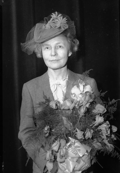 Edith Wilk Willkie (Mrs. Wendell L. Willkie) holding a bouquet of flowers.