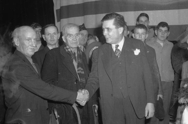 Wendell Willkie shaking hands with Bud Hole (left) and Frank Joslin.