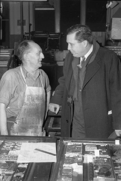 Wendell Willkie speaking with Ed Mergen, "Wisconsin State Journal" veteran typesetter in charge of page layout, in the composing room  during Willkie's 1944 campaign for the Republican Presidential nomination.