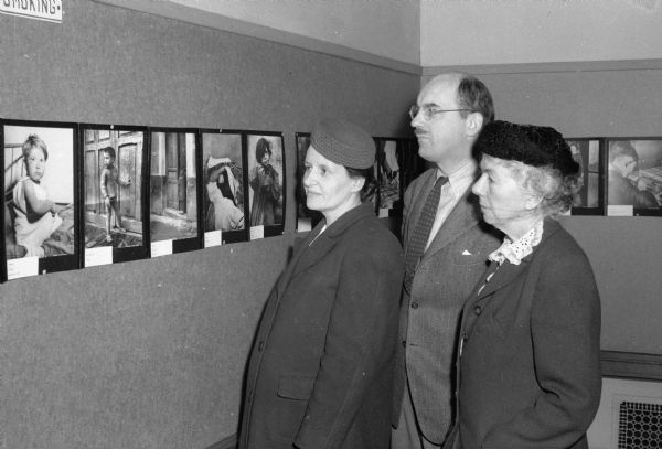 Children of War photography exhibit at the Madison Free Library, viewed by members of the Madison French Relief Society, Mrs. Helene Cassidy, Professor Julian Harris, and Alice Hall.