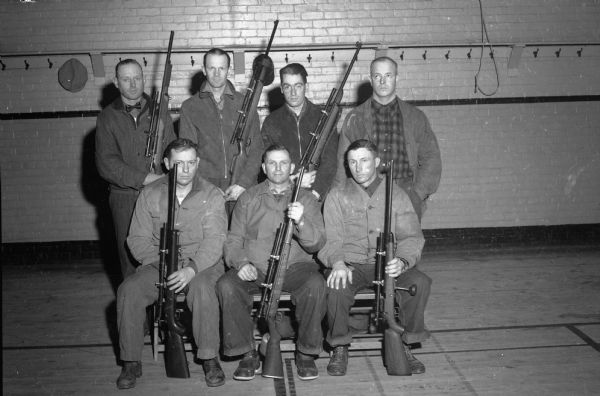 Seven members of the Madison Legion Rifle and Pistol Club.