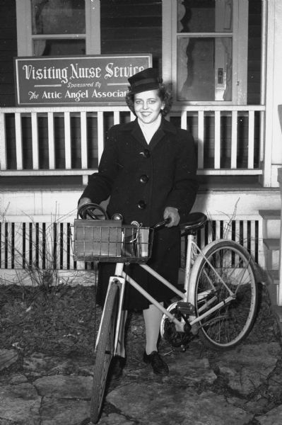 Myra Johnson, 323 West Mifflin Street, the newest member of the Visiting Nurse Service staff, with her bicycle, which she uses to make her daily rounds. Cars were expensive and scarce during war time.
