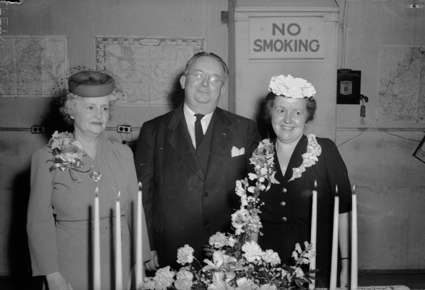 Mrs. Walter S. Goodland, Wisconsin's First Lady, R.C. Tomlinson, USO Club new director, and Mrs. Tomlinson, guests of honor at a tea held at the USO Club. "Get acquainted" meetings were held at the club on Tuesday, Wednesday, and Thursday of last week.