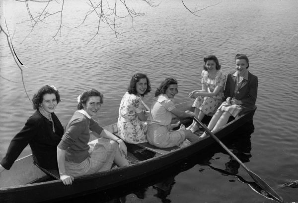 Six sorority girls in a row boat, at the Alpha Phi party on the University of Wisconsin campus.