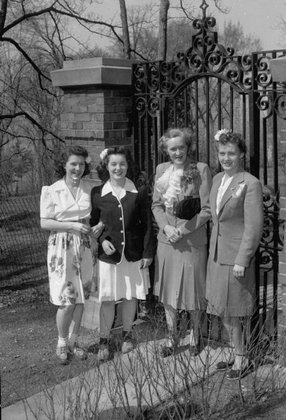 Four women at the Alpha Phi Sorority party, including Helen Kayser, Assistant Dean of Women and guest of honor.
