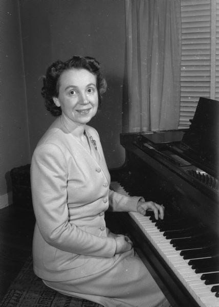 Grace Paris Chatterton sitting at a piano. She was the president of the Wisconsin Congress of Parents and Teachers, aka PTA.