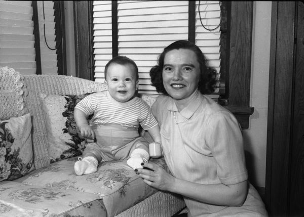 Elinor Neckerman Stege, and her six month old son, Edward Richard "Ricky" Stege, Jr., posing for a Mother's Day portrait. The baby's father, "Ed" Stege, was a star for the University of Wisconsin basketball team during his undergraduate days.