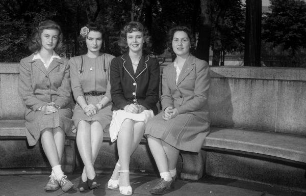 Group portrait of annual city high school track meet Queen and court. Left to right: Ruth Nelson, West High School, daughter of Mr. and Mrs. D.W. Nelson, 3906 Council Crest; Queen Marguerite O'Brien, Central High School, daughter of Mr. and Mrs. Leslie J. O'Brien, Route 3; Lari Ballam, East High School, daughter of Captain and Mrs. C.J. Ballam, 1412 Morrison Street; and Dorothy Damon, Wisconsin High School, daughter of Mr. and Mrs. W.H. Damon, 1533 Madison Street.
