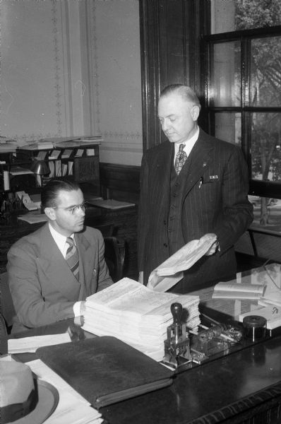 Delbert J. Kenny, Republican from West Bend, filing nomination papers for governor with Gaige E. Roberts, Chief of the Wisconsin Election and Records Division.