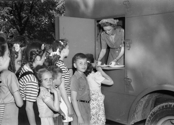 Children in line at the canteen at the Junior Red Cross picnic.