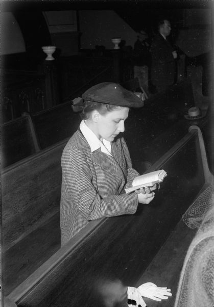 Mary Udulutch, 330 North Carroll Street, praying for her fiancé, Technical Sargent Ronald Whitehall, at the Holy Redeemer Catholic Church, 131 West Johnson Street, before the D-Day Invasion in Europe.