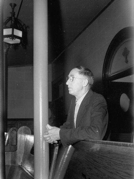 George Kraft, 310 West Washington Avenue, praying at the St. Raphael's Catholic Church for the safe return of his son, Private Robert C. Kraft with the D-Day Invasion's forces.
