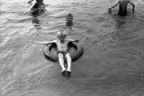 Richard Straavaldsen floating in an inner tube in the water.