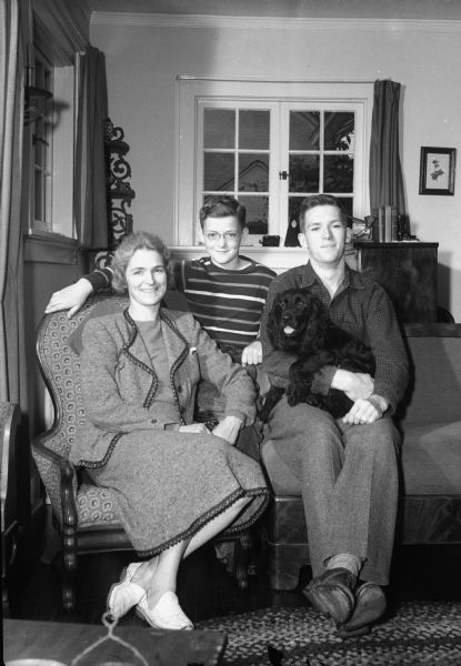 Dorothy Birt (Mrs. Charles Birt), and her two sons, Micheal and David, and their dog Cinder, in their home at 130 Lakewood Boulevard. Major Charles Birt is the Regional Director of Welfare and Education for half of the Allied-Occupation of Italy in WWII.