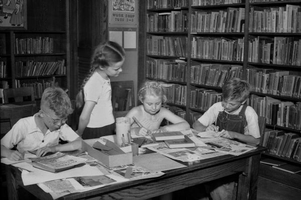 Four children at the Lowell School branch participating in Madison Free Library's summer workshop projects. Left to right: Darrell Premo, Jean LeFebvre, Patricia Elsby, and Walter Jensen.