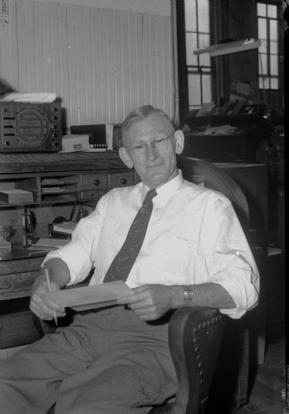 John E. "Hickey" Wilkinson sitting in his office at the Democrat Printing Company from which he is retired after fifty years of service.