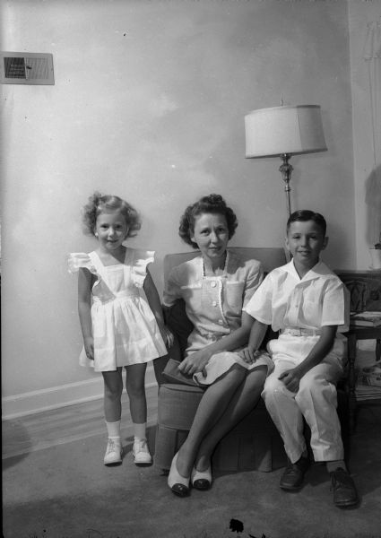 Mrs. Milton (Jean) Donkle and her two children, left to right, Judy and Jimmy, photographed prior to their departure to join Captain Donkle at Camp Crowder, Missouri.