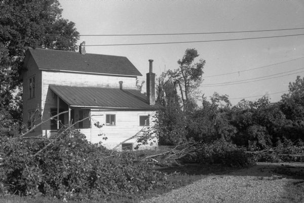 Tornado damage in Truax Field area. The Anderson house chimney was damaged, and the trees surrounding it were uprooted.