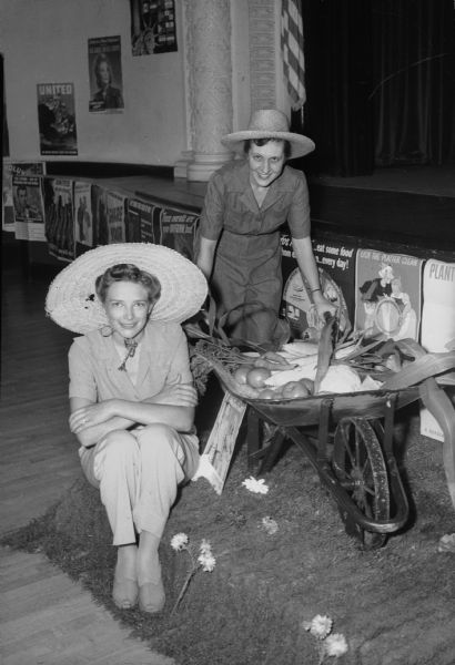 Mrs. Frederick (Marion) Rentschler and Mrs. John R. (Eileen) Frederick, members of the Madison Woman's Club, are shown with produce from their Victory gardens as part of the "Home Front" tea.
