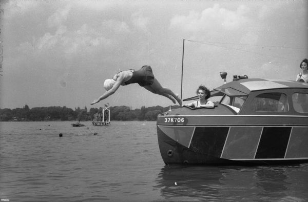 Helen Durr diving from the launch, with Ardith Cauble (Gauble?) observing her.