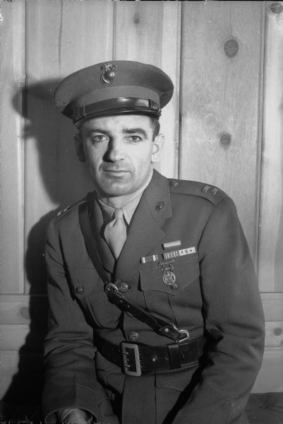 Portrait of Joseph R. McCarthy, Outagamie County circuit judge turned U.S. marine dive-bomber and intelligence officer, is a candidate for the Republican nomination for United States senator in the primary election.  He is shown in his marine captain's uniform with decorations and ribbons won in almost a year and a half's combat service in the Southwest Pacific.