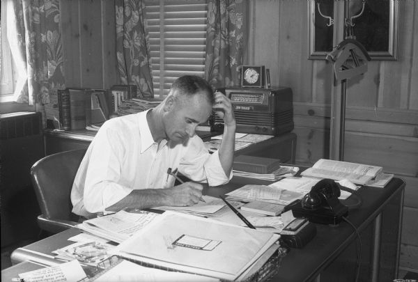 A.A.L., also known as Alva A. Lattimer, columnist and poet whose poems have appeared on the editorial page of the <i>Wisconsin State Journal</i>, working at his desk. He is employed as a field man with the Dane County district of the U.S. Soil Conservation Service. The October 15, 1944, <i>Wisconsin State Journal</i> article includes some of his poems.