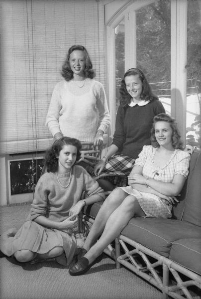 Nancy Marshall, Marianne Havey, Susan Anderson and Karen Brumm, sitting in the home of Richard H. Marshall, 175 Lakewood Boulevard, Maple Bluff, making plans to attend Milwaukee Downer College.