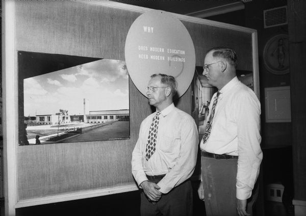 John J. Flad, architect, and John Guy Fowlkes, professor of education at the University of Wisconsin, viewing the exhibit "Modern Architecture for Modern Schools," at the Historical Museum.