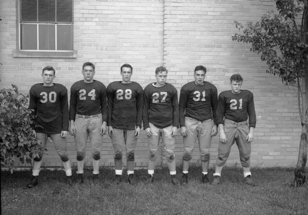 Group portrait of six Edgewood High School football players.  Standing from left: 30 Sweeney, 24 Bill McCormick, 28 Jack Kurth, 27 John Eichman, 31 Ken Koch, 21 Gene Devitt.