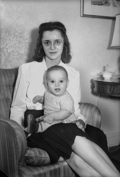 Mrs. Wesley C. Stehr, (Phyllis Bergh) holding son Richard "Dickie." Mrs. Stehr and her son are staying with her parents, Mr. and Mrs. Reid Bergh, 1250 Sherman Avenue, while her husband, Lt. Wesley C. Stehr is stationed in New Guinea.
