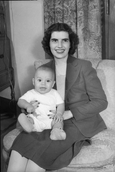 Mrs. Roy B. Larsen (Betty Odegard), holding son Eric. Mrs. Larsen and her son are staying with her mother, Mrs. S.L. Odegard, of Fox Bluff, while her husband, Capt. Roy B. Larsen, is stationed with the medical corps in Oklahoma.
