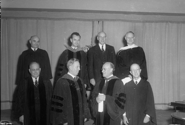 Group portrait of members of the Methodist clergy at the inauguration of newly appointed Bishop Schuyler E. Garth. Top row left to right: Rev. Antonio Parroni, Italian Methodist Church; Rev. Oscar Adam, University Church; Rev. Arthur Dann Willet, South Shore and Trousdale Churches; and Rev. J. Pierce Newell, Madison Supt. of South District. Bottom row left to right: Rev. Robert Atkins, First Church; Bishop Garth; Bishop Ralph Cushman, St. Paul area; and Rev. John Birchall, East Side Church.