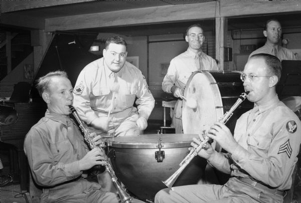 Truax Field soldiers produce a weekly radio show, "Truax Field Calling" for WIBA, broadcasting from the field. Shown at a jam session are, left to right, Pfc. Orval Zink, and Tech. Sgt. Kenneth Baldwin on clarinets, Corp. and Charles O'Brien, and Sgt. Robert Sefcik on percussion.