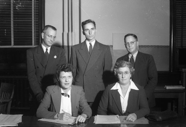 Dane County Executive War Chest Committee, standing left to right: Martin Tollund, Mt. Horeb; Wilbur N. Renk Jr., Sun Prairie; Austin N. Johnson, Madison. Seated from left: Clara Y. Reick, and Mrs. Walter Gregg, Madison. Madison War Chest contributes money to the National War fund to support 21 voluntary agencies working for GIs still in service, including USO, and the Allies.