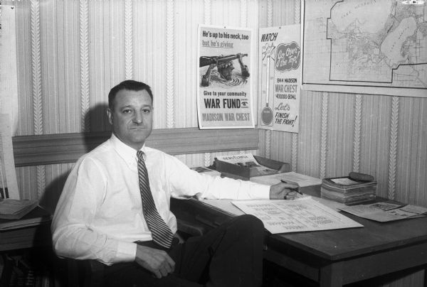Bernhard "Bernie" Mautz, president, general manager, and founder of the Mautz Paint and Varnish Company, at his desk. Mr. Mautz was chairman of Madison's 1944 War Chest campaign. Madison War Chest contributes money to the National War fund to support 21 voluntary agencies working for GIs still in service, including USO, and the Allies.