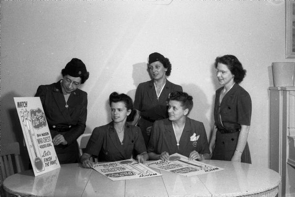 Officers of the Scout Leaders Club being shown how to prepare posters for the War Chest campaign. Left to right: Mrs. William H. Borden (Lucie), president of the club and leader of a Girl Scout Mariner troop; Mrs. Stanley Hungerford (Dorothy); Mrs. Walter Haspell (Lucy); Mrs. W.W. Schareff,(?) and Mrs. John H. Haig (Edna).