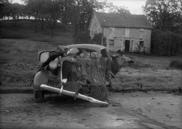 Wrecked car in front of Alma's Inn, 5068 Highway 12-13.  Injured in the accident were five men en route to work at the Badger Ordnance Works at Baraboo.  The men are: Albert E. Smith, 39, Platteville; Horace Berg, 43, Belleville; Norman Harper, 42, Belleville; E.M. Disch, 49, Belleville; and Carlton S. Burke, 41, Belleville.  Alma's Inn was torn down during the expansion of Highway 12 which was completed in 2005.