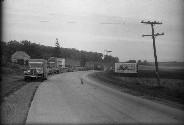Scene of traffic accident in front of Alma's Inn, 5068 Highway 12-13. Injured in the accident were five men en route to work at the Badger Ordnance Works at Baraboo. The men are Albert E. Smith, 39, Platteville; Horace Berg, 43, Belleville; Norman Harper, 42, Belleville; E.M. Disch, 49, Belleville; and Carlton S. Burke, 41, Belleville. Alma's Inn was torn down during the expansion of Highway 12 which was completed in 2005.