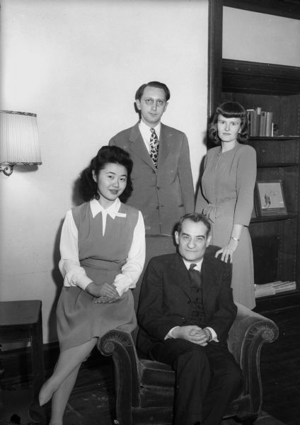 Group portrait of Ruby Kubota, a Japanese-American student and president of the Groves Women's Co-operative house, 625 North Henry Street; Prof. Selig Perlman (seated), the guest speaker; and Donald and Kerttu Schwartz, who serve as house parents.  Taken during an open house held at the co-op.