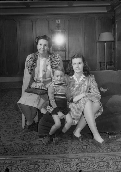 Group portrait of Mrs. Agnes Miller, married and divorced from Tim McCoy, Western movie star, with her daughter, Mrs. Dudley (Rita) Vernon-Smith, and grandson, Rodney Vernon-Smith. Agnes Miller was the daughter of theatrical producer, Henry Miller, and sister of New York producer, Gilbert Miller. Agnes Miller remarried B.I. Loomis. While in Madison she worked at The Perfume Shop owned by Mrs. Marius Hansen.