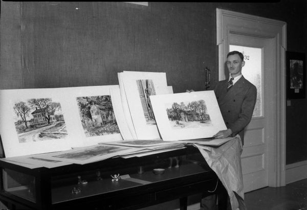 Max Fernekes of Mineral Point with a display of his watercolors and sketches for a one-man show at the State Historical Museum. He was also a featured artist speaking on "Wisconsin Regional Art."