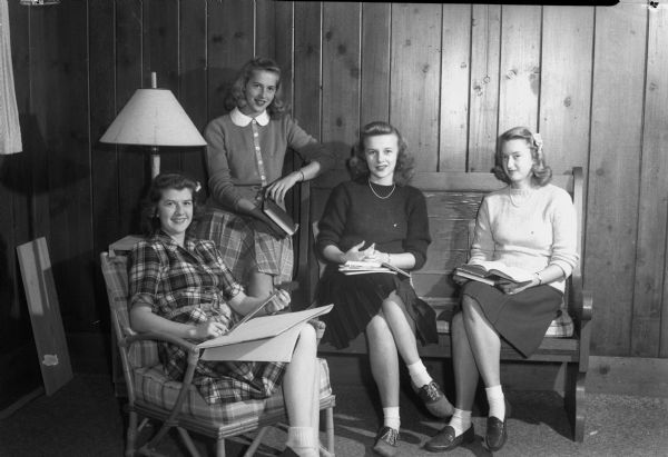 Four student pledges of Pi Beta Phi sorority of the University of Wisconsin, studying. The pledges include Betty Brannon, Madison, daughter of Mr. and Mrs. William Brannon; Carol Woods, Bluefield, Virginia; Ruth Roberts, Wisconsin Rapids; and Barbara Hunt, East Lansing, Michigan.