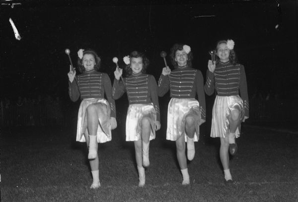West High School drum majorettes in uniform at the East-West High School football game at Breese Stevens Field. From left are Carlene Doran, Dawn Rebenstorff, Jackie Stafford, and Martha Klein. The game ended in a 7-7 tie.