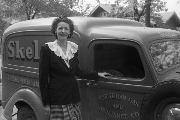 Miss Imogene Boggs, membership chairman of the Business and Professional Women's Club, standing next to her truck. She was the owner of the Suburban Gas and Appliance Company and the only woman dealer for the Skelgas Service in the midwest.