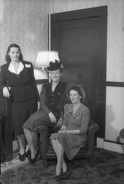 Three officers' wives at the Madison Army Officers' Wives club meeting held at the Capital Hotel. From left to right: Mrs. Paul Hohf, Mrs. Byron Caldwell, and Mrs. Robert Mallory.