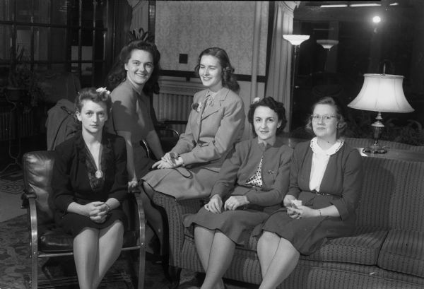 Five officers' wives at the Madison Army Officers' Wives club meeting held at the Capital Hotel. From left to right: Mrs. Thomas Holstein, acting president; Mrs. Robert Orwin, chairman of arrangements; Mrs. John Sufranski, program chairman; Mrs. Leslie Gilbert, treasurer; and Mrs. Frank Heibold, chairman of special interest groups.