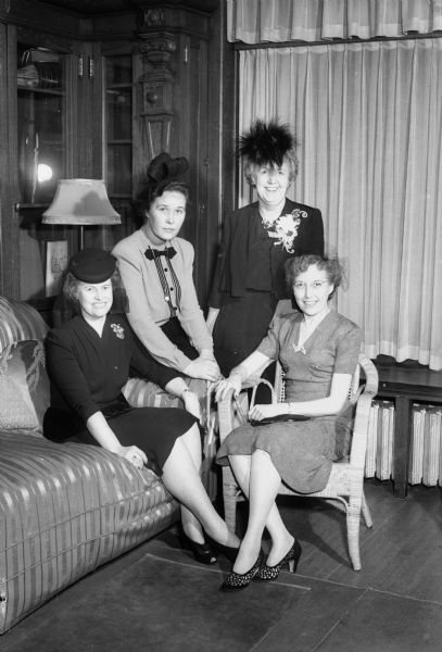 Group portrait of four members of the Zonta International Club, a classified service club for executive women, taken at an inter-city meeting held at the College Club. From left to right: Marjorie Gile, president of the Madison chapter; Lucile Nielsen, president of the Milwaukee chapter; Kate Certa, president of the Chicago loop chapter, and Ethel Coleman, president of the Oak Park chapter.