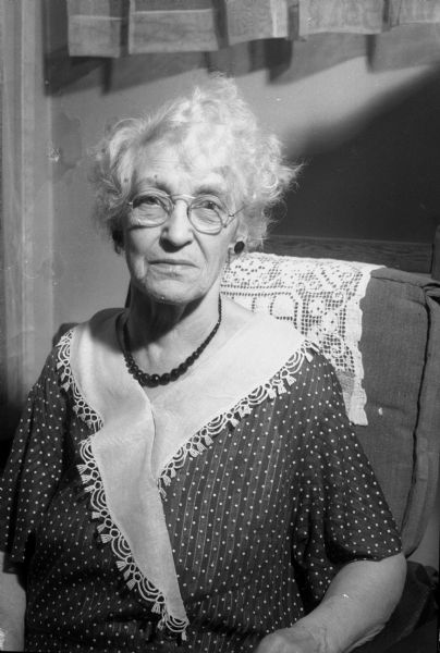 Portrait of Mrs. Anna Silbernagel Kurz, reminisces about her father, Jacob Silbernagel, an early downtown Madison businessman for a story in the <i>Wisconsin State Journal</i>.