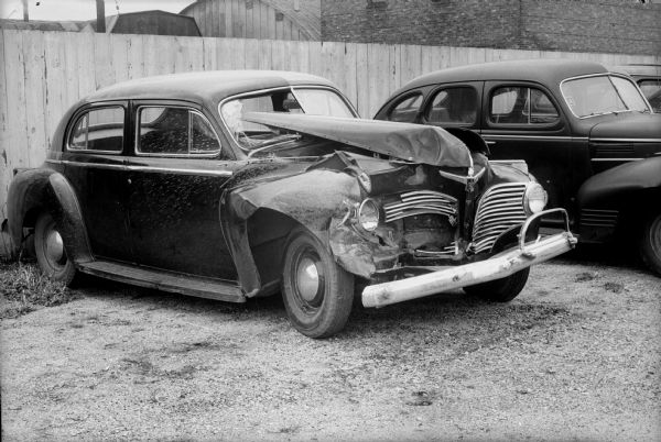 Automobile with damage to left front hood and fender at Gillespie-Blumer Motors Inc., 814 East Washington Avenue.
