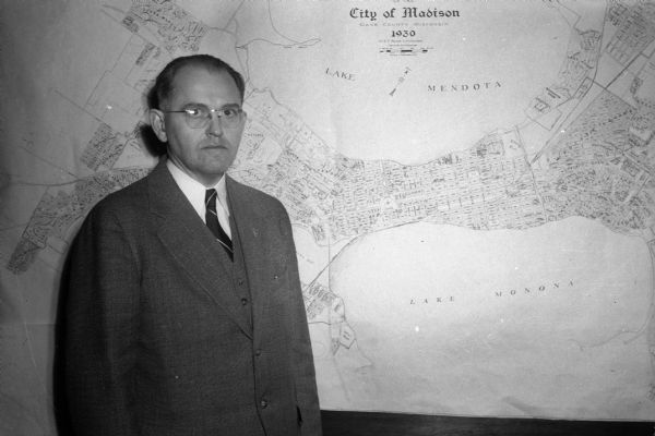 Mayor F. Halsey Kraege standing in front of a 1930 City of Madison map.